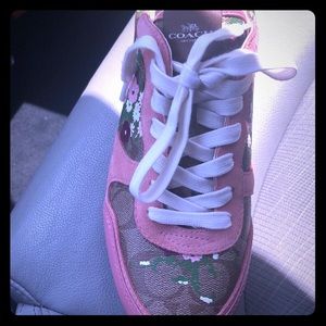 A pair of tenis shoes pink by coach new